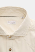Close-up front view of the Brunello Cucinelli Cord Shirt Shark Collar Cream showing fine cotton corduroy, shark collar, snap button placket, and western-style yoke.