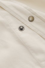 Close-up front detail of Brunello Cucinelli Cord Shirt Shark Collar Cream showing snap button, corduroy cotton fabric, and stitching from a top-down perspective.