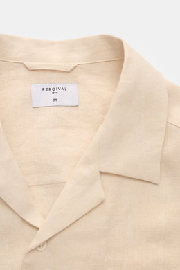 Close-up front view of Percival Linen short sleeve shirt Cuban collar beige, showcasing its airy, lightweight pure linen fabric and typical texture.

Description: <p>Cool, lightweight and antibacterial: Linen’s natural qualities make it the perfect summ