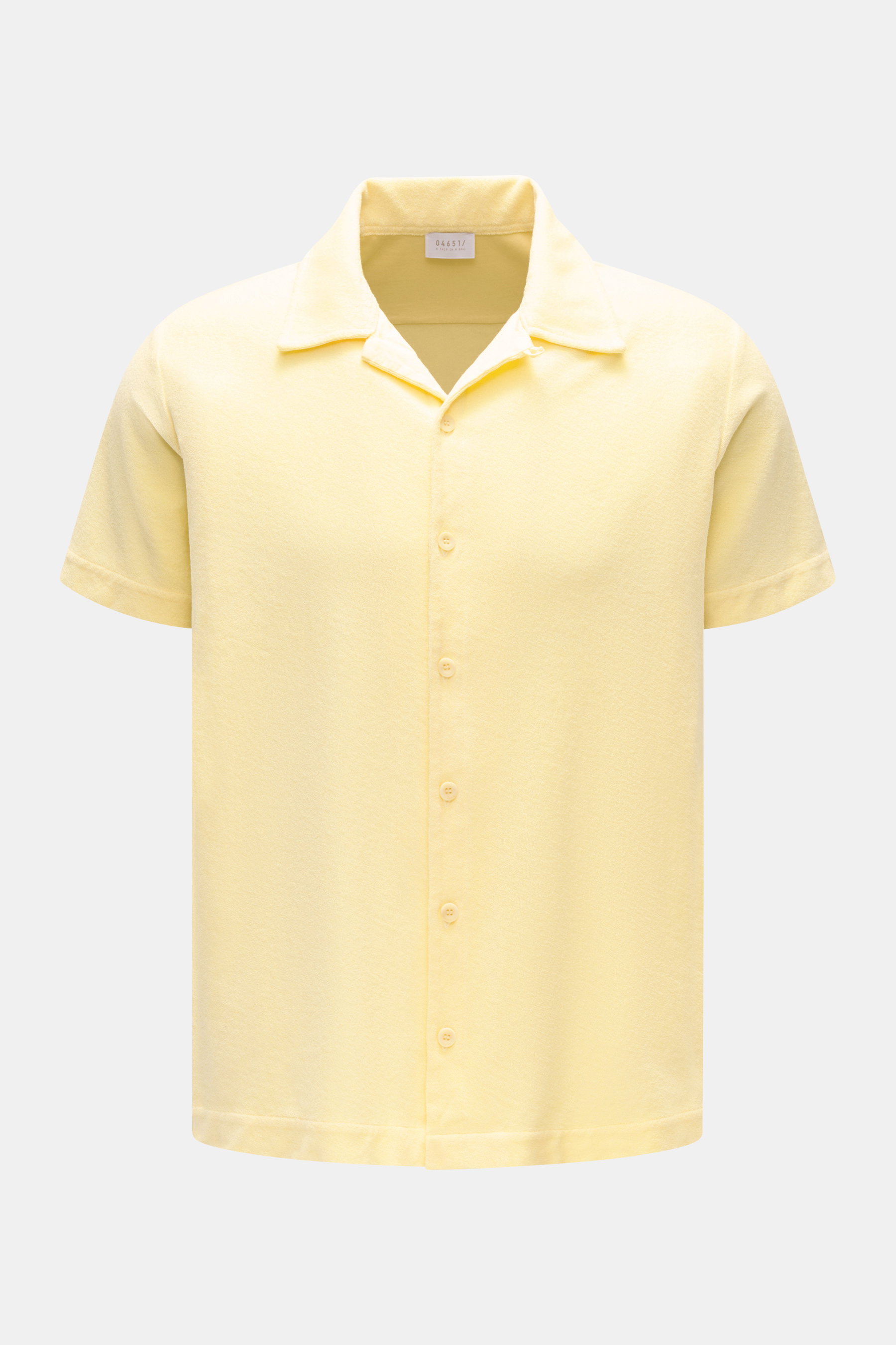Front view of 04651/ A trip in a bag Frottee-Kurzarmhemd 'Terry Cuba' pastellgelb, a pastel yellow short-sleeve shirt in soft pure cotton terry fabric with a variable Cuban collar, French button placket, small side seam label, short hem slits, and regular