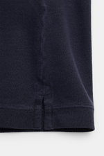 Close-up side hem detail of the Stone Island Polo shirt navy, showing the navy cotton piqué texture and side vents from a front perspective.

<p>The classic from STONE ISLAND: This sporty polo shirt in cotton piqué is a casual men’s wardrobe must-have.</p