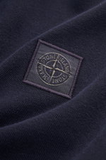 Close-up of the Stone Island Polo shirt navy fabric showing the textured cotton piqué with the STONE ISLAND fabric label, photographed from a detailed angled top view.

Description: 
<p>The classic from STONE ISLAND: This sporty polo shirt in cotton piqué