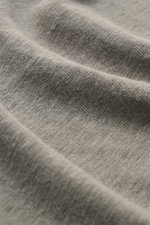 Close-up front view of the fabric texture of the 04651/ A trip in a bag Linen jersey polo shirt grey-green, showing breathable, slightly elastic linen jersey with smooth touch. This casual, piece-dyed jersey polo shirt from 04651/ A TRIP IN A BAG is made 