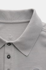 Canada Goose Poloshirt 'Beckley' grau, Nahaufnahme von oben, Baumwoll-Piqué, Polokragen, Drei-Knopfleiste, Brust-Patch sichtbar.