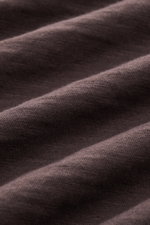 Close-up front view of dark brown pure cotton fabric texture of the B.F. Knitwear Jersey polo shirt dark brown with a soft feel and classic polo collar. Uncomplicated classic: This jersey polo shirt by B.F. KNITWEAR is a versatile basic for the warmer mon