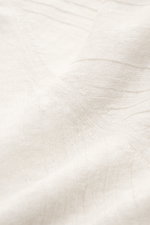 Close-up front angled view of 04651/ A trip in a bag Short sleeve knit polo 'Johnny' cream showing fine knit and subtle striped texture.

<p>Modern classic: This short sleeve knit polo by 04651/ A TRIP IN A BAG has a clean striped look that makes a stylis