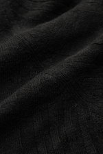 Close-up front perspective of 04651/ A trip in a bag Short sleeve knit polo 'Johnny' black showing fine knit texture and subtle striped pattern.

<p>Modern classic: This short sleeve knit polo by 04651/ A TRIP IN A BAG has a clean striped look that makes 