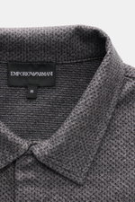 Close-up front view of the Emporio Armani Jersey Polo Shirt Grey Melange collar and logo label, showcasing its textured cotton microfiber jersey.

<p>Sporty casualness: The EMPORIO ARMANI polo shirt combines a comfortable quality with a casual jersey desi