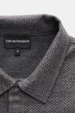 Close-up front view of the Emporio Armani Jersey Polo Shirt Grey Melange collar and logo label, showcasing its textured cotton microfiber jersey.

<p>Sporty casualness: The EMPORIO ARMANI polo shirt combines a comfortable quality with a casual jersey desi