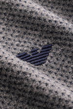 Close-up front view of the grey melange fabric with logo stitching on the chest of the Emporio Armani Jersey Polo Shirt Grey Melange.

Description: Sporty casualness: The EMPORIO ARMANI polo shirt combines a comfortable quality with a casual jersey design
