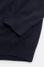 Close-up front perspective of the von Braun Cashmere knit polo navy, highlighting elasticated ribbed bands on the sleeve, pure cashmere fine knit, slim fit, three-button placket, and signature polo shirt collar. Elegant basic for the cold season with a ve
