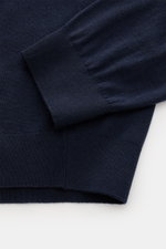 Close-up view of the sleeve and hem of the von Braun Merino knit polo navy, showcasing its pure merino wool, soft feel, very fine knit, regular fit, signature polo shirt collar, open collar strip, and elasticated ribbed bands. 

<p>An elegant basic for ca