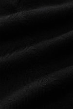 Close-up front view of the von Braun Merino knit polo black, showing its pure merino wool texture, soft feel, very fine knit, signature polo collar with open collar strip, elasticated ribbed bands, and regular fit, an elegant basic for casual looks.