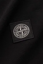 Close-up of the Stone Island Long sleeve polo shirt black showing the tonal STONE ISLAND compass logo patch on pure cotton jersey fabric, photographed from a top-down perspective. <p>Create casual outfits that work with this classic long sleeve polo shirt