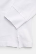 Close-up view of the cuff and side vent of the Stone Island Long sleeve polo shirt white, showing pure cotton jersey in robust piqué texture with elasticated, garment-dyed fabric.

<p>Create casual outfits that work with this classic long sleeve polo shir