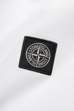 Close-up top-down view of Stone Island Long sleeve polo shirt white showing black compass logo patch on white garment-dyed cotton piqué fabric.

<p>Create casual outfits that work with this classic long sleeve polo shirt in an understated sporty look in p