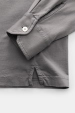 Close-up view of the cuff and side hem slits of the Fedeli Jersey Longsleeve Polo Shirt 'Zero' grey, made of smooth, sustainable Giza organic cotton jersey with mother-of-pearl button.