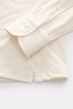 Close-up front view of the Fray Jersey longsleeve polo shirt 'Parigi' cream showing the classic sport cuff with a button, made of a soft mix of cotton and cashmere, featuring a regular fit, classic polo collar, and four-button placket.