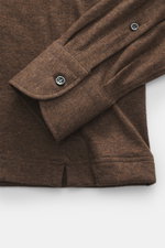 Close-up top-down view of the cuff and lower sleeve of the Fray Jersey longsleeve polo shirt 'Parigi' brown melange, showing soft mix of cotton and cashmere fabric, regular fit, classic polo collar, four-button placket, and classic sport cuff.