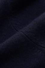 Close-up detail of the Soft Goat Cashmere knit polo navy, showing the medium-fine knit texture and comfortable ribbed bands from a top-down perspective, highlighting the pure cashmere, very soft feel, regular fit, and open collar placket that give it an e