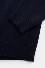 Close-up view of Soft Goat Cashmere knit polo navy sleeve and hem showing ribbed bands, medium-fine knit, and soft texture.

Description: 
<p>Pared down to the essentials: This long sleeve knit polo in pure cashmere by SOFT GOAT has a simple design and an