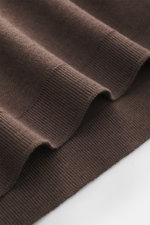 Nahaufnahme des dunkelbraunen 04651/ A trip in a bag Longsleeve-Poloshirt 'Wool TP Polo LS' im Regular Fit, Jersey aus Baumwolle und Wolle, strukturierter Griff, komfortable Rippbündchen, fotografiert von oben.
