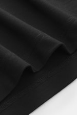 Close-up image of black fabric showing the fine texture and stitching details of 04651/ A trip in a bag Longsleeve polo shirt 'WJ' black, photographed from a top-down perspective, featuring a blend of wool and high-quality microfiber, soft touch, regular 