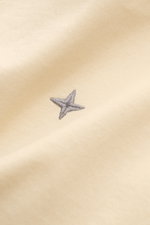 Nahaufnahme des Stone Island Rundhals-T-Shirts 'Stellina' pastellgelb mit dezentem Stellina-Stitching auf Jersey aus reiner Baumwolle.
