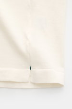 Close-up of the hem with short side slits of the Fioroni Rundhals-T-Shirt offwhite, finely knitted from pure cotton.

<p>Für den gediegenen Auftritt im Frühling sorgt dieses fein gestrickte T-Shirt von FIORINI, welches aus reiner Baumwolle gefertigt wurde