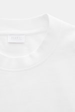 Close-up front view of 04651/ A trip in a bag T-shirt 'Nunu' white showing crew neck and label. A basic with a print accent: With its Copenhagen inspired print, this T-shirt by 04651/ A TRIP IN A BAG makes a modern statement and is the ideal piece for urb