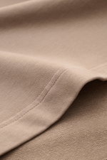 Close-up front-side view of the taupe fabric and stitching of the 04651/ A trip in a bag Crew neck T-shirt 'If Tee' taupe.

Description: <p>The uncomplicated cotton T-shirt 'IF Tee' by 04651/ A TRIP IN A BAG is a core basic for the new season that give us
