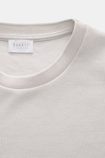 Nahaufnahme vom Rundhalsausschnitt des 04651/ A trip in a bag Piqué-T-Shirt 'TP' hellgrau aus reiner Baumwolle mit komfortablen Rippbündchen und kernigem Griff, Slim Fit, Weblabel in der Seitennaht, fotografiert von oben.