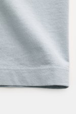 Close-up front view of Stone Island Crew Neck T-Shirt 'Organic Cotton' smoky blue fabric showing soft texture and stitched hem.

Description: <p>Timeless, versatile, and sustainable: The STONE ISLAND t-shirt impresses as a modern casual essential. Made fr