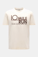 Golden Goose Crew Neck T-Shirt Cream shown from the front, cream color with bold "10 MILE RUN" lettering, pure cotton, heavy quality, regular fit, crew neckline. A bold statement for warm days: The T-shirt by GOLDEN GOOSE stands out with a striking print 