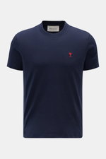 A front view of the Ami Paris Crew Neck T-Shirt Navy, a slim fit crew neck made from pure cotton jersey with a soft feel and red heart stitching on the chest.  

<p>Classic jersey basic from the French label AMI PARIS: This crew neck T-shirt is made fro