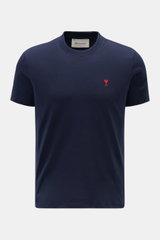A front view of the Ami Paris Crew Neck T-Shirt Navy, a slim fit crew neck made from pure cotton jersey with a soft feel and red heart stitching on the chest.  

<p>Classic jersey basic from the French label AMI PARIS: This crew neck T-shirt is made fro