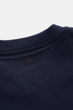Close-up rear view of Ami Paris Crew Neck T-Shirt Navy showing ribbed crew neckline, tonal AMI stitching on pure cotton jersey fabric.

Description: 
<p>Classic jersey basic from the French label AMI PARIS: This crew neck T-shirt is made from pure cott