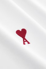 Close-up front view of Ami Paris Crew Neck T-Shirt white showing red heart stitching on pure cotton jersey fabric.

Description: 
<p>Classic jersey basic by the French label AMI PARIS: This crew neck T-shirt is made of pure cotton and an everyday favorite