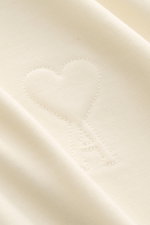 Close-up front view of Ami Paris Crew neck T-shirt cream showing quilted heart logo on heavy, soft pure cotton jersey fabric.

Description: <p>Pardon my French – with this T-shirt by AMI PARIS you’ll get by even without good language skills, because the q