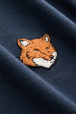 Close-up front view of the navy Maison Kitsuné Crew Neck T-Shirt 'Fox Head' showing the typical embroidered fox patch on soft pure cotton jersey fabric.

<p>Sporty essential from MAISON KITSUNÉ: With the typical fox patch on the chest, this shirt will be 