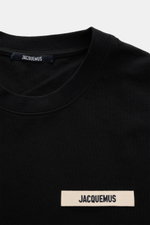 Close-up front view of Jacquemus Crew Neck T-Shirt Black showing pure cotton fabric, soft touch, slim fit, and grosgrain with logo stitching on chest.