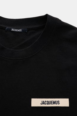 Close-up front view of Jacquemus Crew Neck T-Shirt Black showing pure cotton fabric, soft touch, slim fit, and grosgrain with logo stitching on chest.