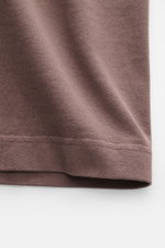 Close-up image of Jacquemus Crew Neck T-Shirt Grey Brown fabric photographed from a front angle, showing pure cotton, soft touch, slim fit, and Grosgrain with logo stitching on the chest.