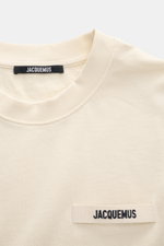 Jacquemus Crew Neck T-Shirt cream shown from a close-up front perspective, pure cotton, soft touch, slim fit, grosgrain with logo stitching on chest.