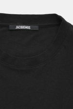 Close-up front top view of Jacquemus Crew neck T-Shirt black showing neckline and logo label, pure cotton, soft touch, slim fit, logo print on the front.