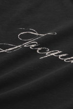 Close-up top-down view of the Jacquemus Crew neck T-Shirt black, showing the logo print on the front, made of pure cotton with a soft touch and slim fit.