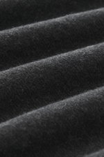 Close-up image showing the fine, diagonal structure and soft touch of the dark grey melange fabric of the Jacquemus Crew Neck T-Shirt 'Le Ruban,' photographed from a macro perspective, highlighting the jersey made of pure cotton. Features include regular 