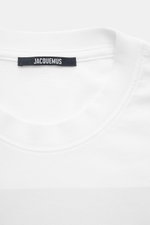 Close-up front view of Jacquemus Crew neck T-Shirt white showing neckline and label, pure cotton, soft touch, slim fit, distinctive print on front.