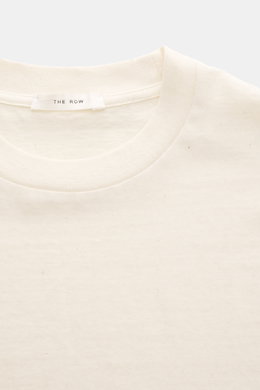 The Row Crew neck T-Shirt 'Maiko' cream shown from a top-front close-up, made from noble washed cotton jersey with soft touch, pure cotton, regular fit, and crew neckline, featuring fine slubs for a vintage-inspired character that matures over time.