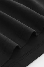 Close-up front view of Maison Kitsuné Crew neck T-Shirt black fabric, showing pure cotton, slightly textured feel, regular fit, boxy cut, crew neckline, and distinctive fox print on the chest.